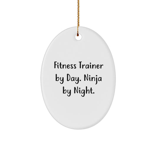 Fitness Trainer Gifts: Funny Oval Ornament for Friends, Coworkers, and Family with 'Fitness Trainer By Day. Ninja By Night.' Quote, White, 3.25" Tall, Christmas Unique Gifts - Image 1